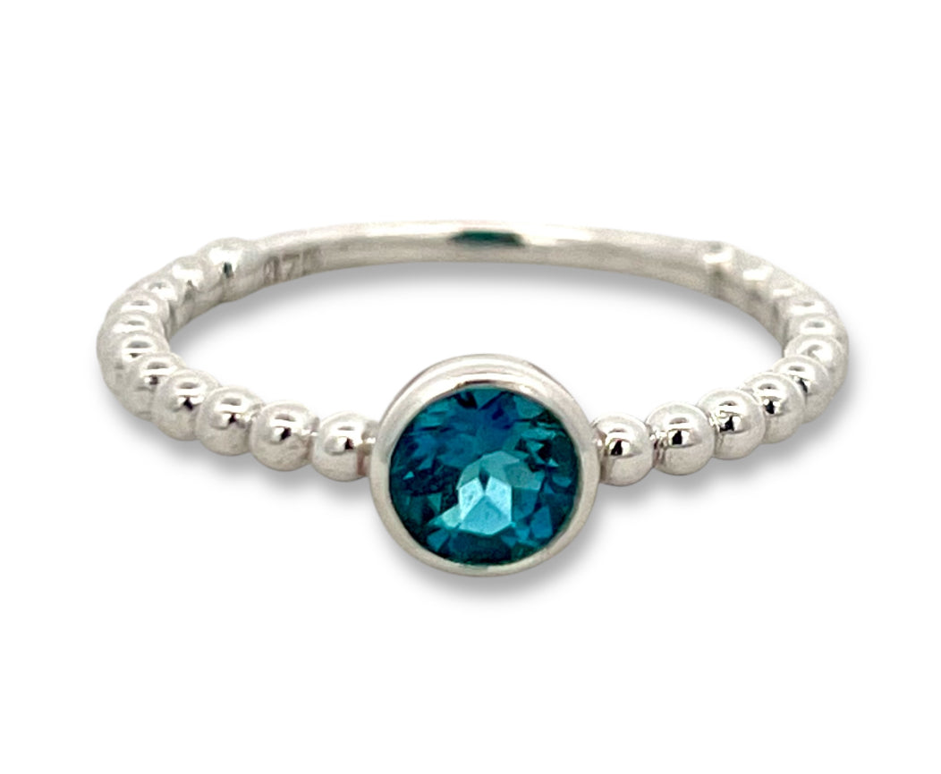 Bezel set topaz ring